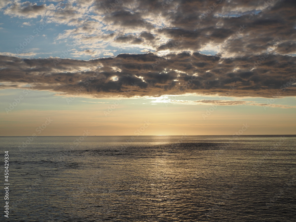 sunrise with clouds over atlantic ocean