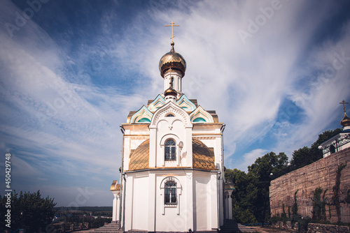 Orthodox temple (chapel) and blue sky with clouds.