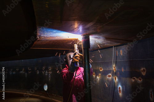 Welding male worker metal is part in machinery nozzle pipeline construction © chitsanupong