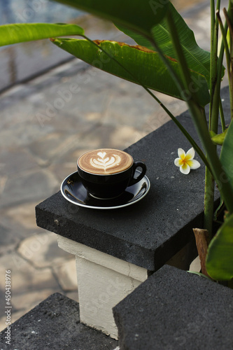 a hot cappuccino with latte art while enjoy afternoon time at cafe	 photo