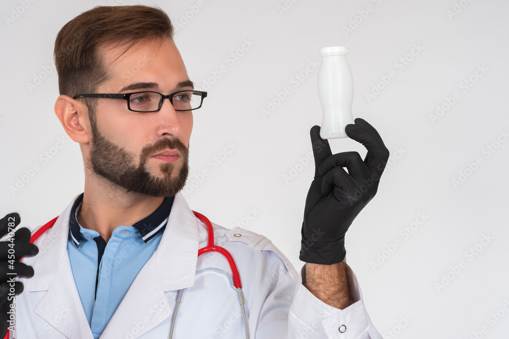 Healthy foods. Foods fortified with probiotics. A male doctor is holding a bottle of fortified yogurt. Proper nutrition. Prevention of dysbiosis. Healthy foods. Foods fortified with probiotics. A male doctor is holding a bottle of fortified yogurt. Proper nutrition. Prevention of dysbiosis.