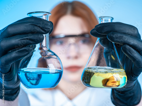 Hands of a chemist in black...