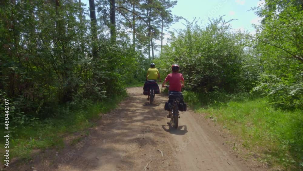 Two cyclists drive out of the forest to the seashore.
Young bikers with backpacks ride bicycles along a picturesque road. Two cyclists drive out of the forest to the seashore.
Young bikers with backpacks ride bicycles along a picturesque road.