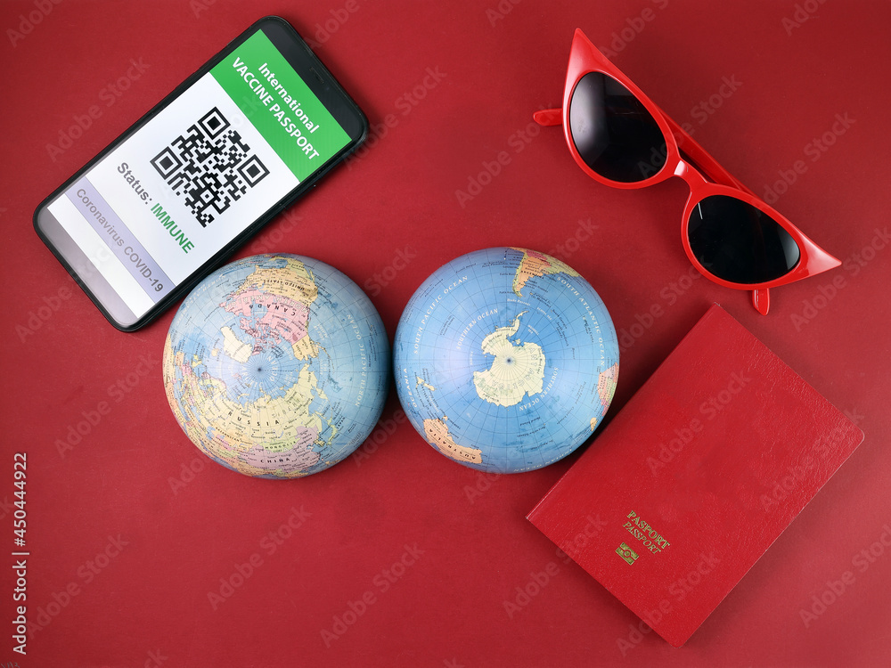 Vaccine passport smartphone app red sunglass world atlas globe map north south pole on red paper background world travel tour vacation Vaccine passport smartphone app red sunglass world atlas globe map north south pole on red paper background world travel tour vacation