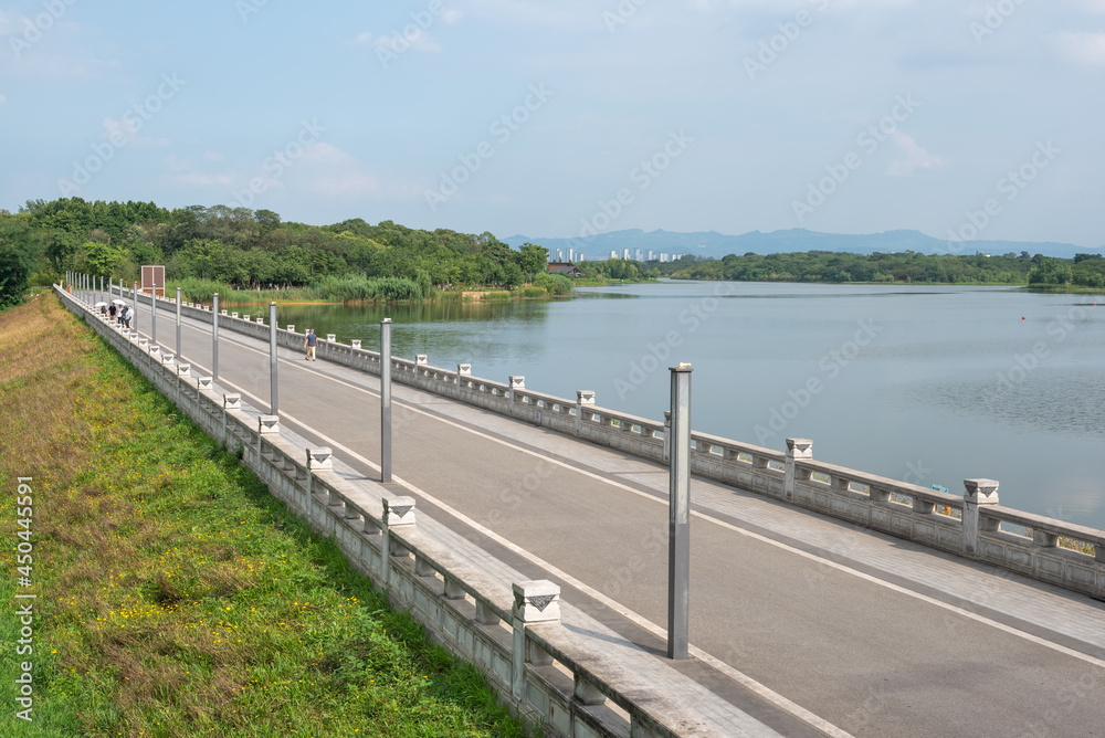 Pedestrian road by a lake in a QingLongHu park in Chengdu, Sichuan province, China Pedestrian road by a lake in a QingLongHu park in Chengdu, Sichuan province, China