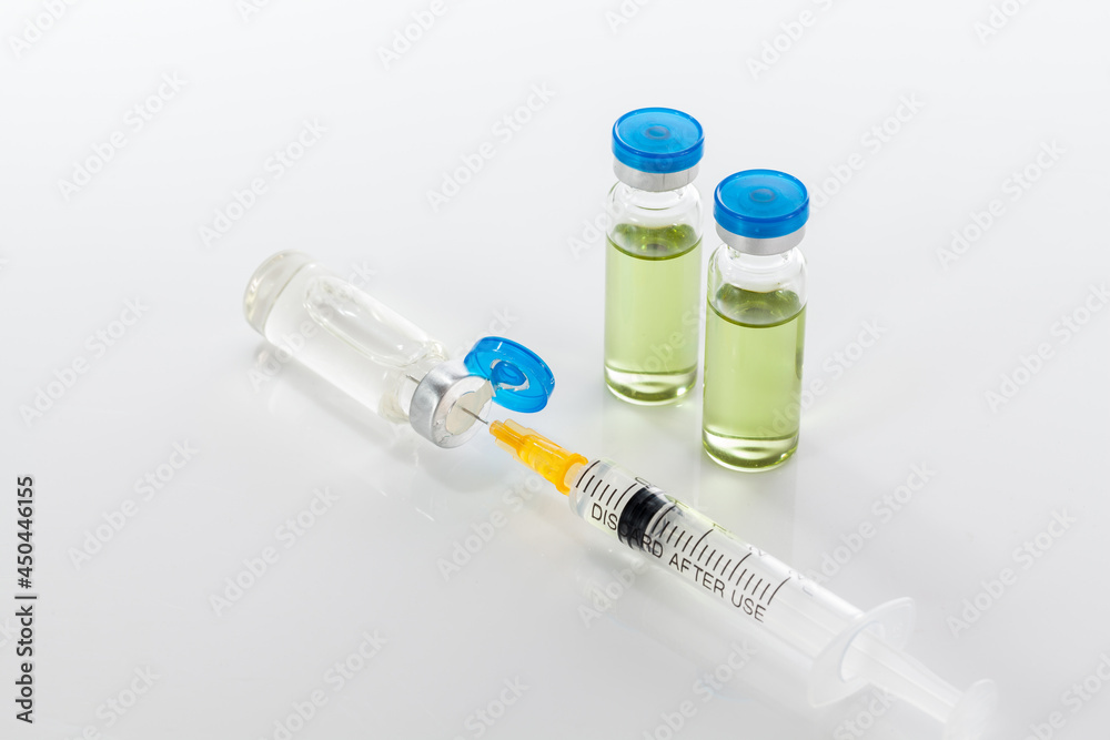 Vaccine bottles and syringe on white backround. Vaccine bottles and syringe on white backround.