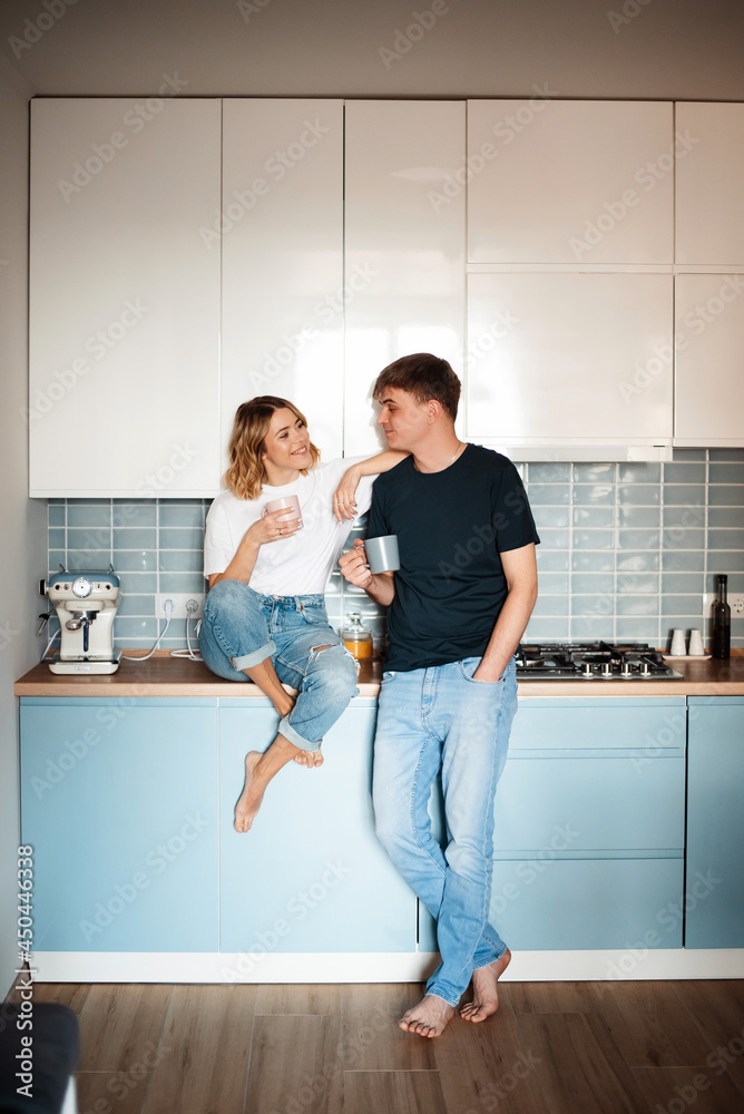 Caucasian couple chatting and drinking coffee at home