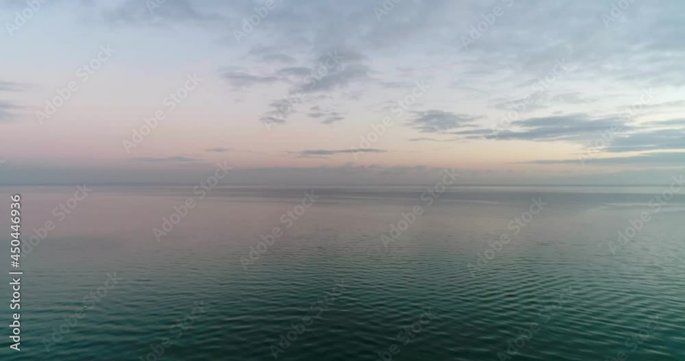 Drone flying Over Calm blue bay orange Horizon of tranquil Clouds early morning Drone flying Over Calm blue bay orange Horizon of tranquil Clouds early morning
