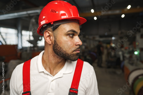 Portrait of young tired african american workman in cable production plant
