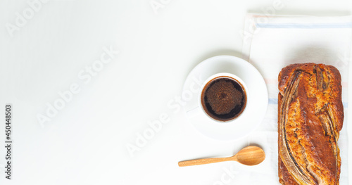 Flat lay of fresh homemade banana bread and a cup of coffee on white background. healthy diet breakfast. photo