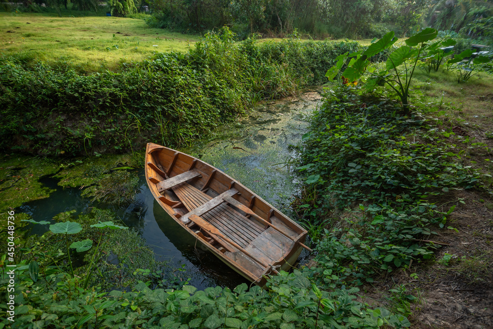 Wooden rowboat on the banks of the river Wooden rowboat on the banks of the river