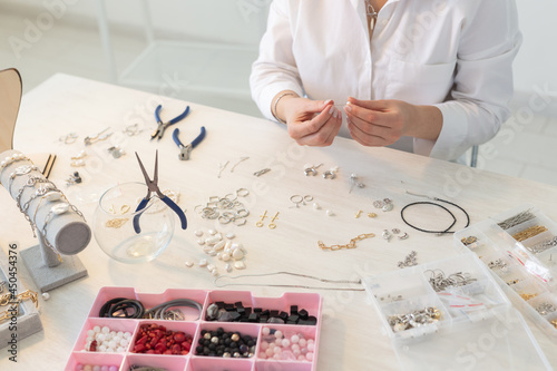 Obraz na plátně Professional jewelry designer making handmade jewelry in studio workshop close up