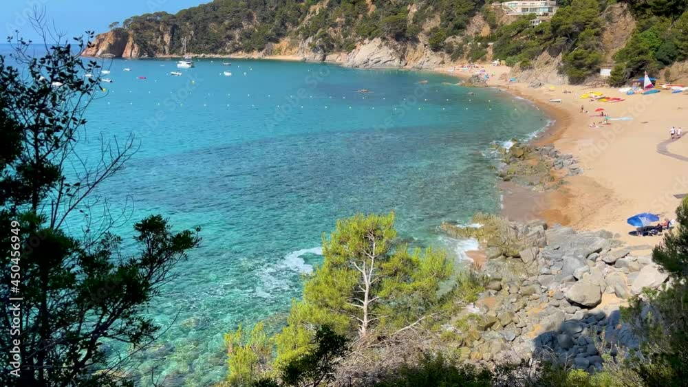 Costa Brava beautiful virgin beach with transparent turquoise waters lush vegetation of pine trees and rocks yellow sand Gerona Catalonia Mediterranean Panoramic views Tossa de Mar cove Llevadó Costa Brava beautiful virgin beach with transparent turquoise waters lush vegetation of pine trees and rocks yellow sand Gerona Catalonia Mediterranean Panoramic views Tossa de Mar cove Llevadó