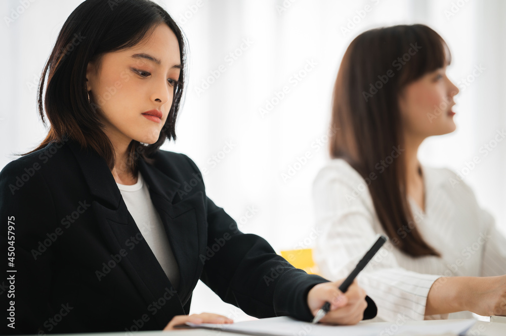 Asian business hold a small meeting inside the office or conference room. Brainstorm to exchange ideas. There are stock boards Laptops and tablets are communication tools. Unity teamwork concept. Asian business hold a small meeting inside the office or conference room. Brainstorm to exchange ideas. There are stock boards Laptops and tablets are communication tools. Unity teamwork concept.