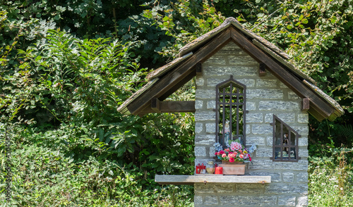 popular devotion, floral tributes to a chapel in the woods dedicated to the Virgin Mary. Piedmont, Italy. © gpriccardi