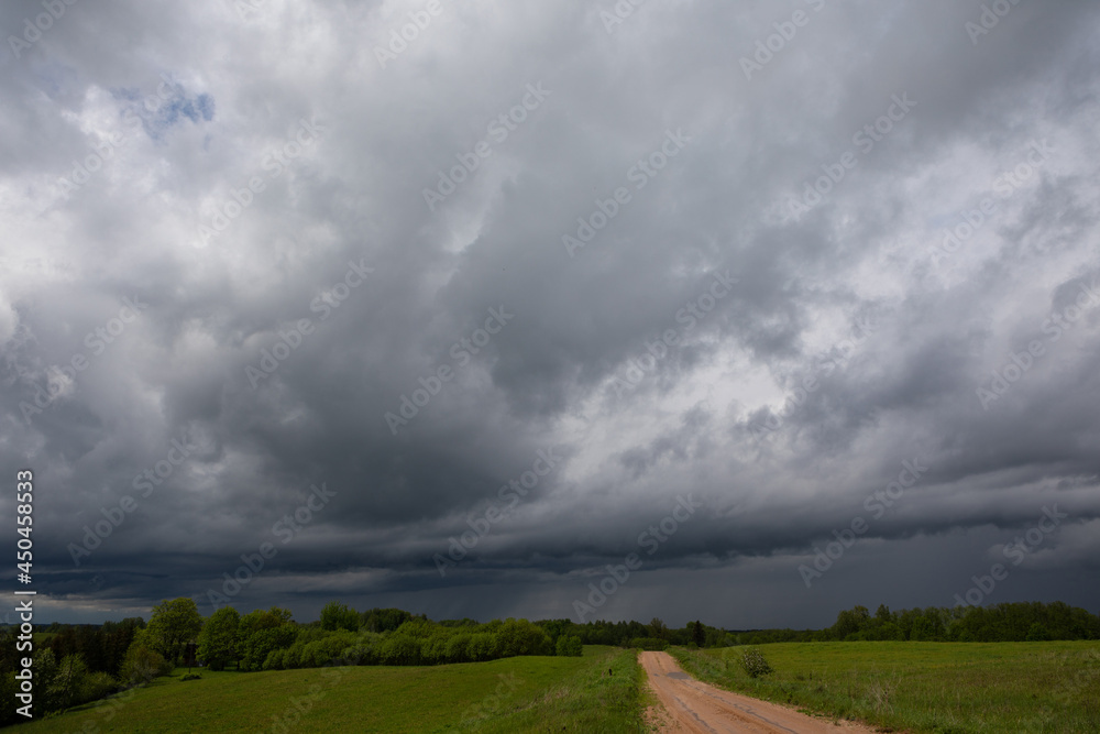 Big skies with the stormy clouds and rain in the distance Big skies with the stormy clouds and rain in the distance
