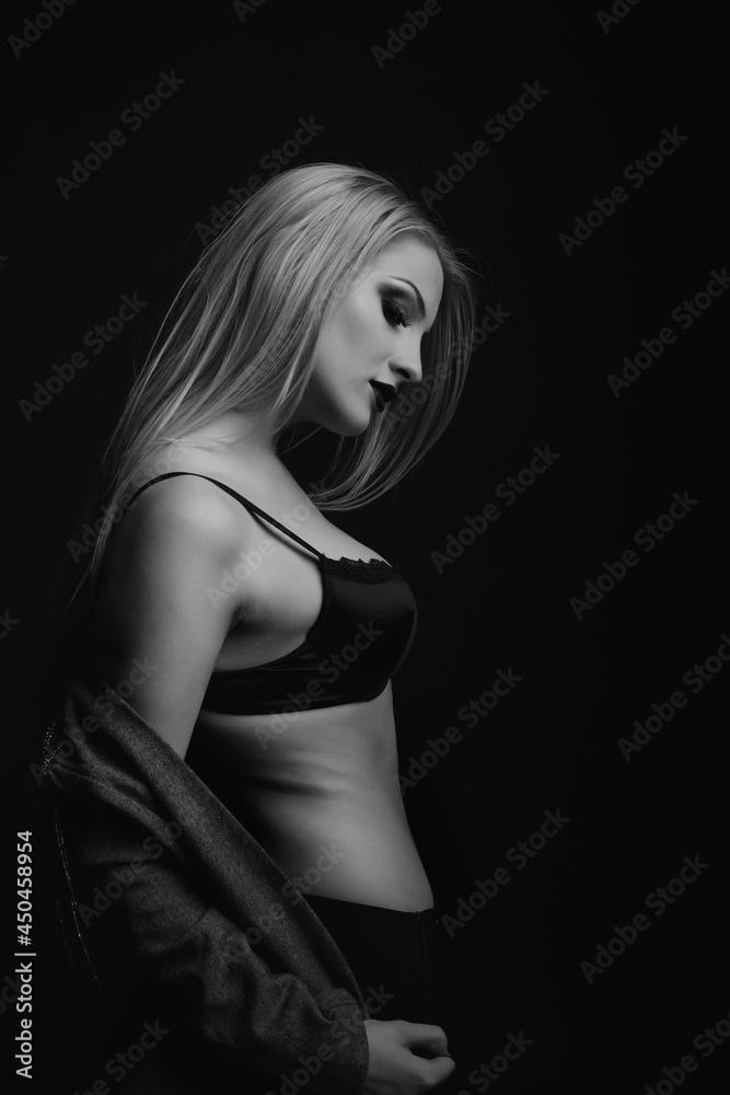 Sensual model wears bra and jacket posing at studio Sensual model wears bra and jacket posing at studio
