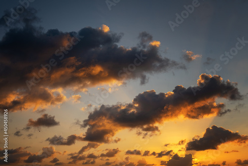 Beautiful sky of bright orange and blue color with clouds, abstract natural phot and texture, wallpaper