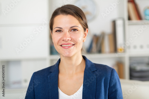 Portrait of young elegant confident smiling businesswoman in modern office ..