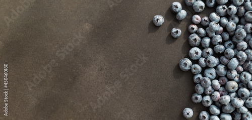 Blueberries ripe and tasty on a black background. Top view, rustic style.