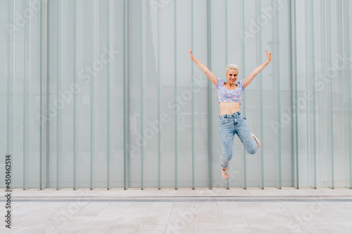 Young caucasian woman outdoor jumping celebrating success feeling free - advertising copyspace