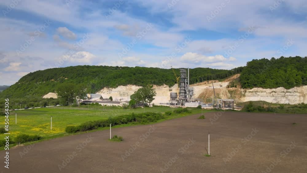 Cement factory at open pit mining of construction sand stone materials with excavators and dump trucks. Cement factory at open pit mining of construction sand stone materials with excavators and dump trucks.