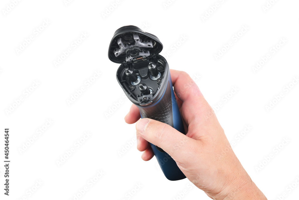 Male hand holds an electric shaver on a white isolated background. Male hand holds an electric shaver on a white isolated background.