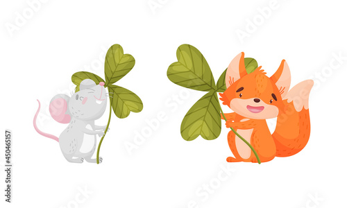 Cute baby animals with three leaf clover set. Adorable mouse, fox holding shamrock leaves cartoon vector illustration