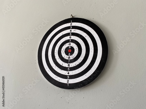 A black and white arrow board is attached to the wall. Focus on the red dot in the middle and reach the target that has been prepared