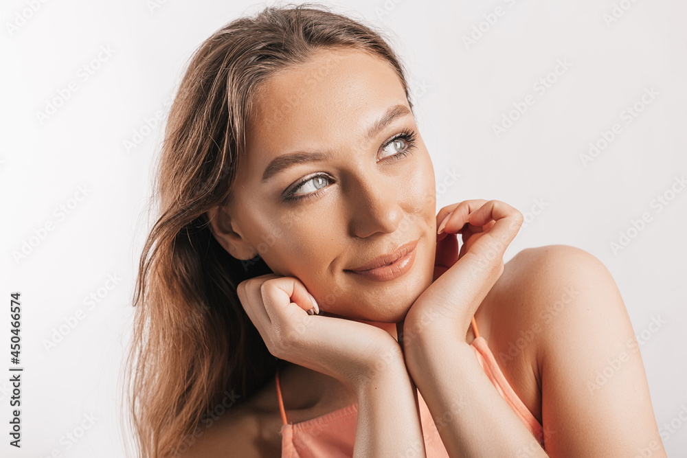 Beautiful young girl smiling and posing looking at the camera on a white isolated background. Positive brunette woman. Kind look. Beauty face Beautiful young girl smiling and posing looking at the camera on a white isolated background. Positive brunette woman. Kind look. Beauty face