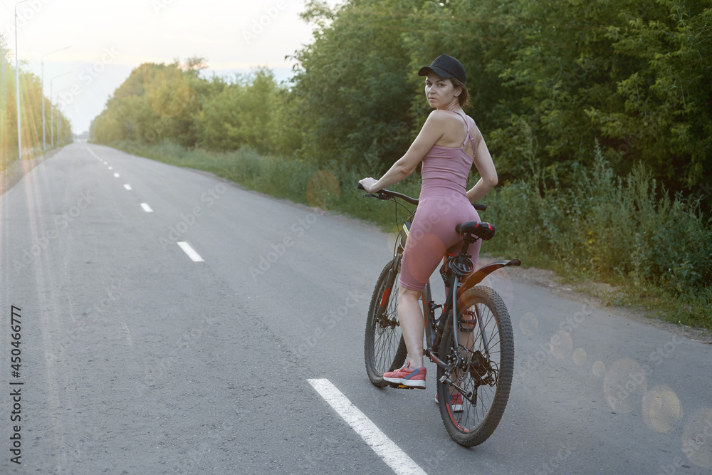 The girl cyclist is engaged in sports, the concept of a healthy lifestyle The girl cyclist is engaged in sports, the concept of a healthy lifestyle