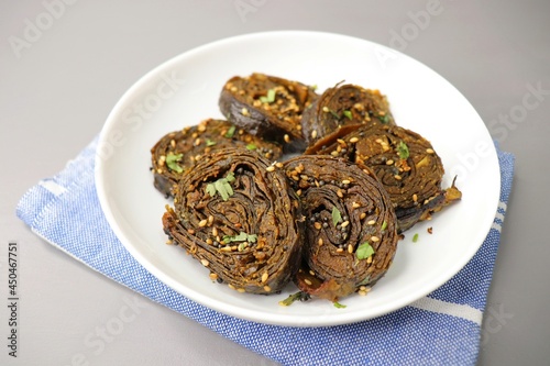 Alu Vadi, Patra, paatra, colocasia leaves roll, Patrode is a popular Indian healthy steamed snack. Garnished with sesame and mustard seeds. copy space. photo
