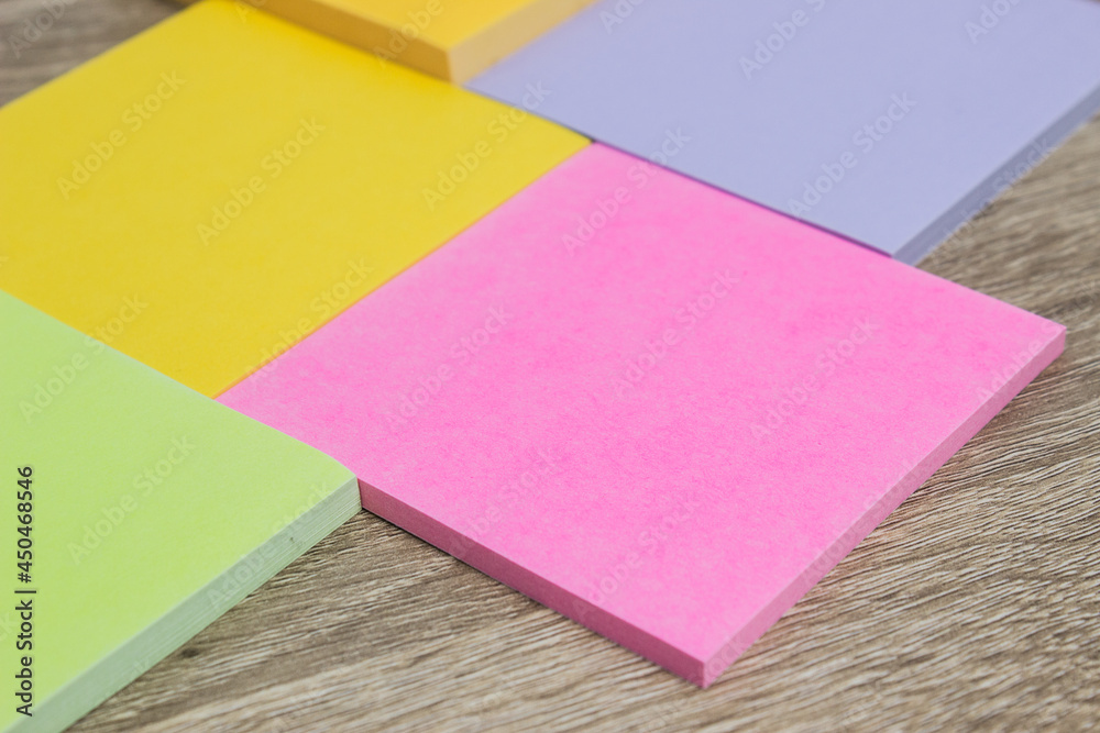 Colorful sticky notes on wooden background