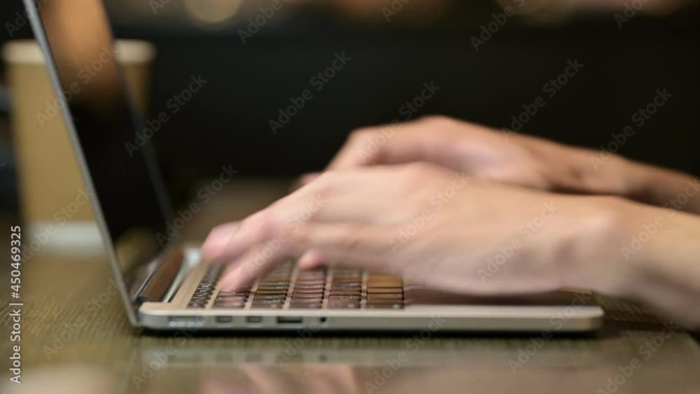 Closeup 4K video of a man working at home and typing on laptop Closeup 4K video of a man working at home and typing on laptop