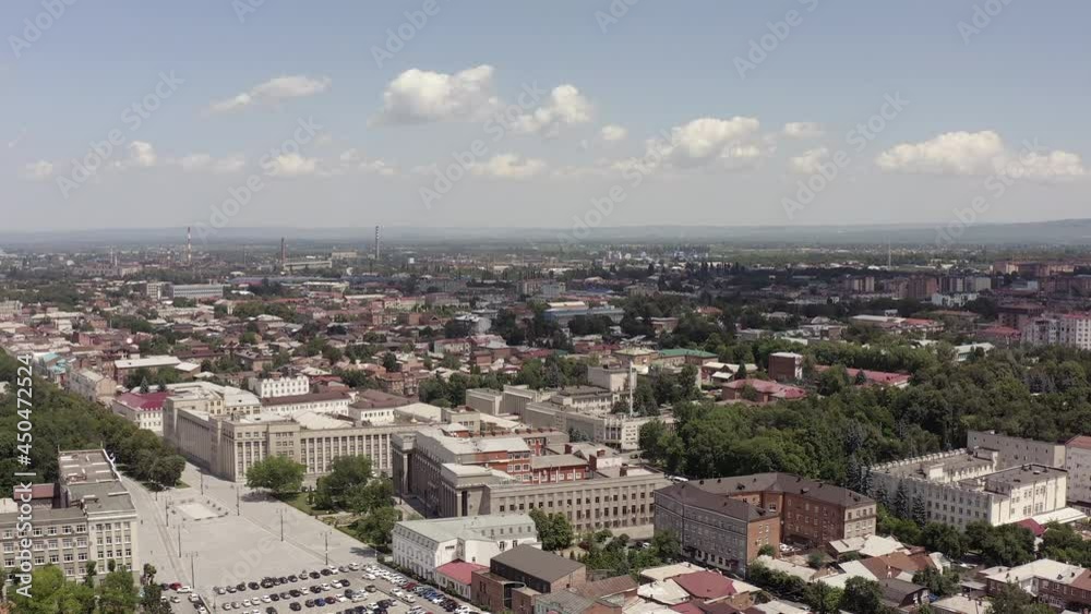 A beautiful city landscape from a bird's eye view. Aerial view of Vladikavkaz city, buildings, trees, parks. A beautiful city landscape from a bird's eye view. Aerial view of Vladikavkaz city, buildings, trees, parks.