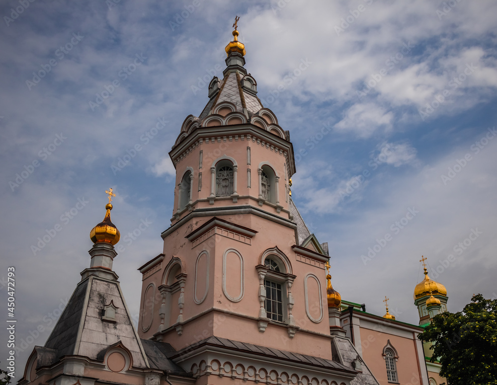View of the facade of the Koretsky Convent against the background of a cloudy sky. Ukraine.