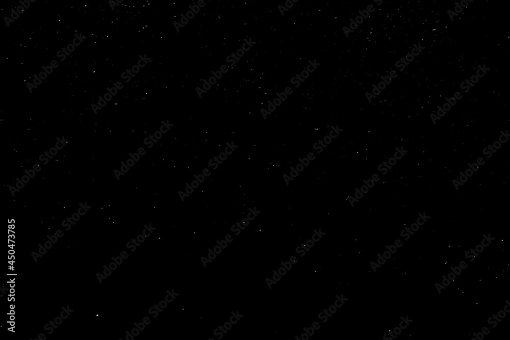 Obraz premium Falling snow on a black background. small particles with bright dots starry sky. Сhaotic white bokeh. light spots texture. abstract.