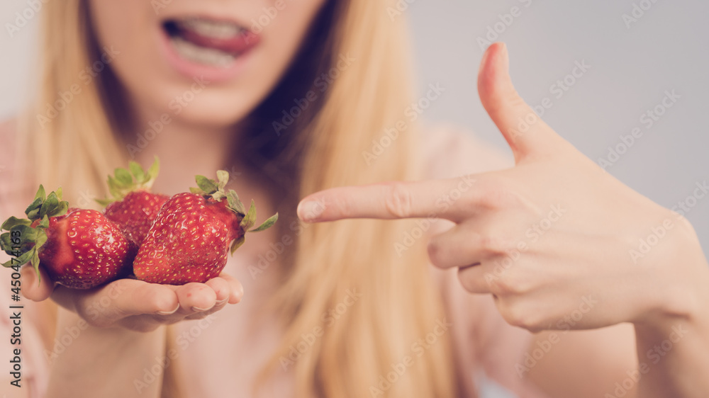 Girl showing fresh strawberries