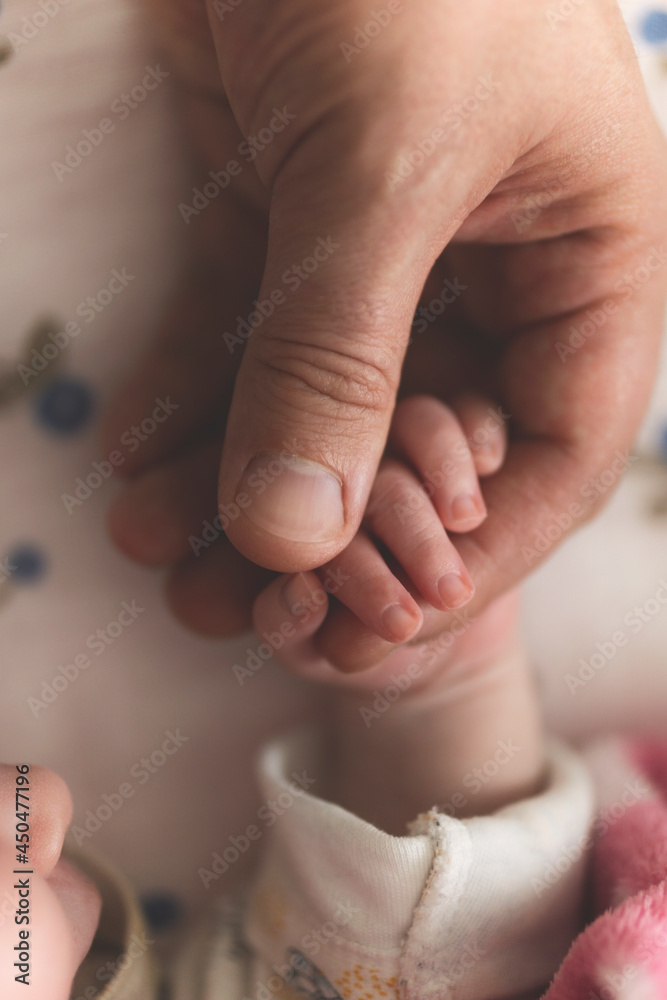 Close up of newborn baby holding dad's finger Close up of newborn baby holding dad's finger