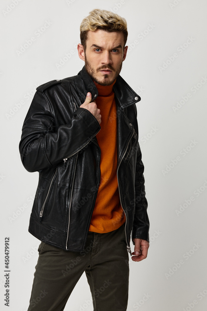 handsome blond man in orange sweater and leather jacket close-up portrait handsome blond man in orange sweater and leather jacket close-up portrait