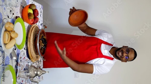 A Moroccan cook presents his plate of lamb with plums on the table