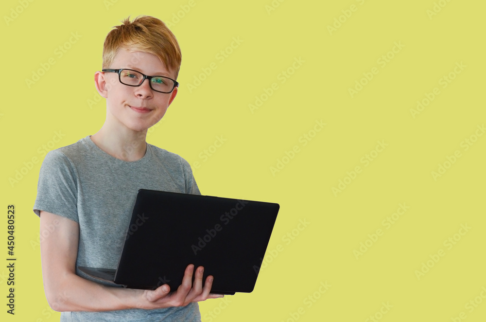 portrait of a smart, confident child with glasses and a laptop, the concept of online education and home learning portrait of a smart, confident child with glasses and a laptop, the concept of online education and home learning