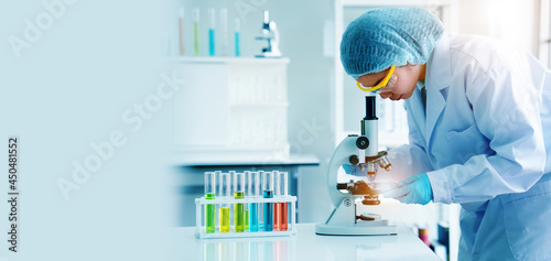 Scientist or doctor use microscope to test for the coronavirus (COVID 19). Or a new flu virus to save people life In the lab Or hospital. Success in research the treatment of patient