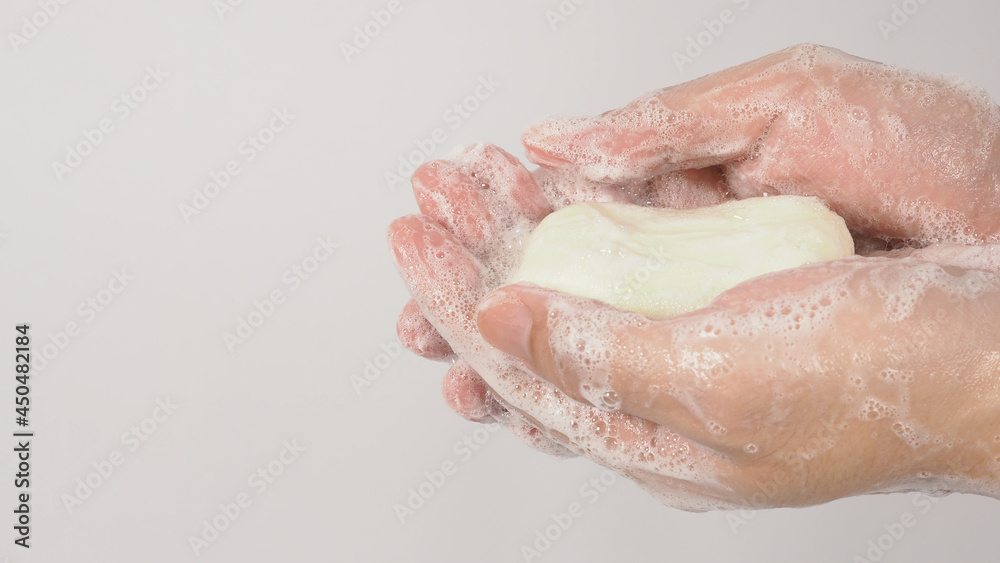 Hands washing gesture with bar soap and foam bubble on white background. Hands washing gesture with bar soap and foam bubble on white background.