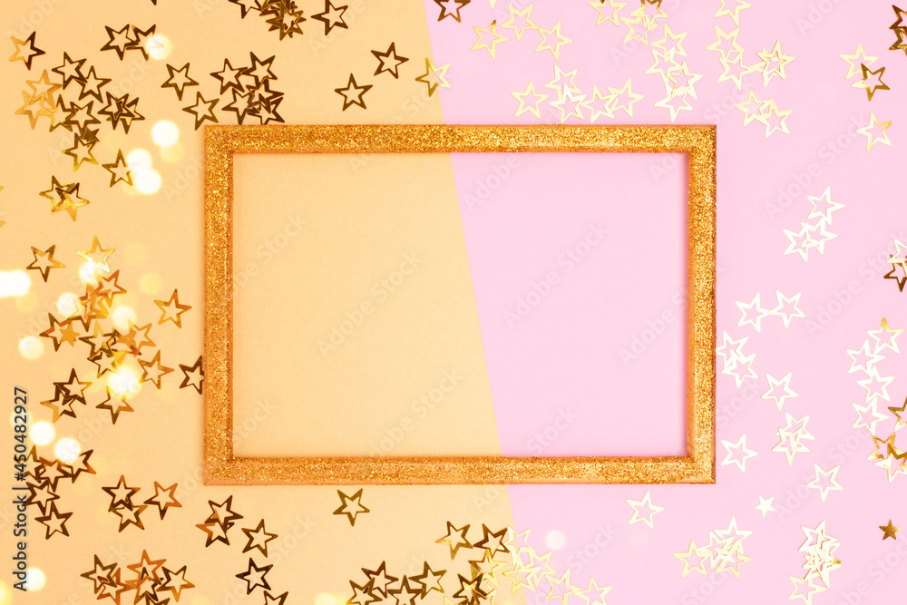 Glittering empty frame with stars confetti. Festive concept with copy space on a pink and gold background.
