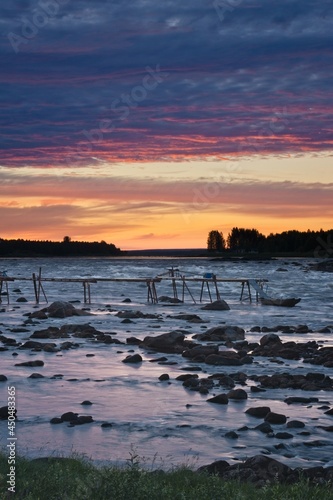 River Torneälven on the Swedish-Finnish border just after sunset. View from Kukkolaforsen in Sweden.