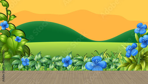 Flower field and green grass with mountain backdrop at sunset time