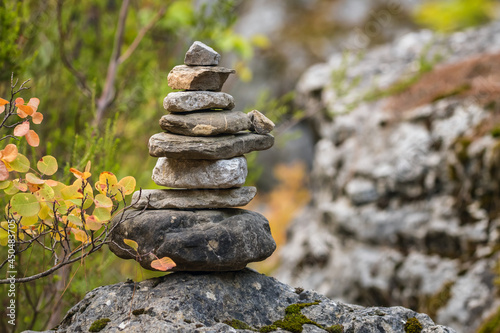 Balance stones on the rock in autumn forest photo