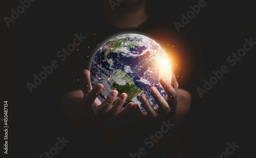 Fototapeta Naklejka Na Ścianę i Meble -  Earth inside of two hands for earth day and saving energy environment concept ,Element of this image from NASA and 3d render.