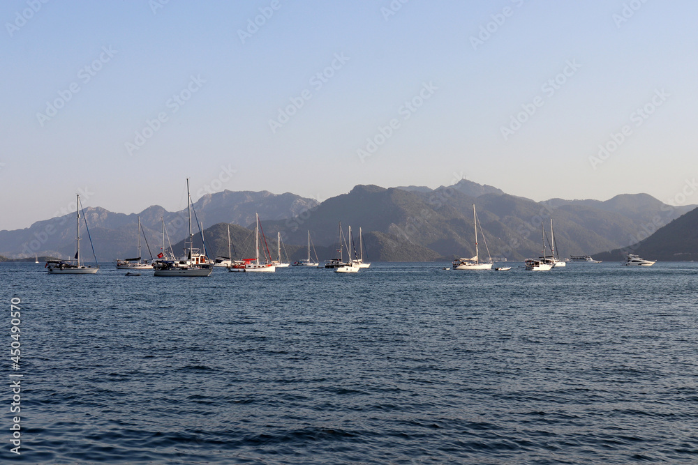 Yachts in the bay of Marmaris on the Aegean sea on mountains background. Turkish coast, summer travel